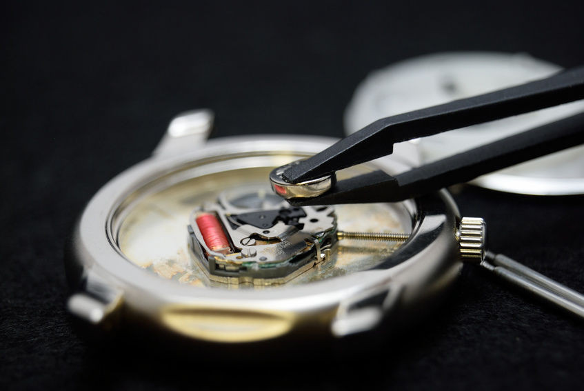Kỹ thuật viên đang kiểm tra đồng hồ Casio sau khi thay pin, đảm bảo chất lượng và bảo hành