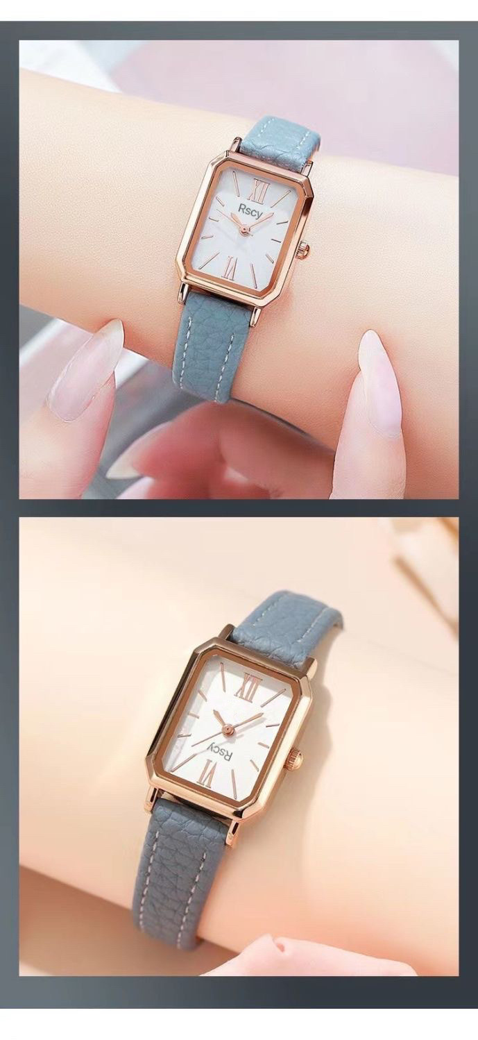 Một chiếc đồng hồ đeo tay nữ mặt nhỏ màu xanh lam sẫm, dây da cùng màu, đặt trên nền vải mềm mại, làm nổi bật vẻ đẹp tối giản và hiện đại.