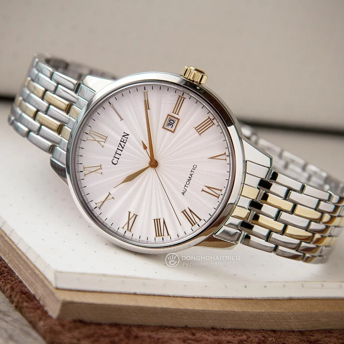 Chiếc đồng hồ nam màu vàng đẹp Citizen NJ0084-59A với mặt số Sunburst Guilloche cuốn hút.