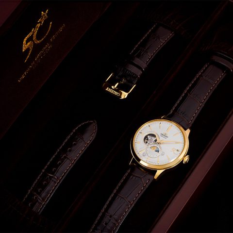 Đồng hồ Orient phiên bản đặc biệt RA-AS0105S30B trên nền trắng, mặt số trắng sang trọng với kim và cọc số vàng.